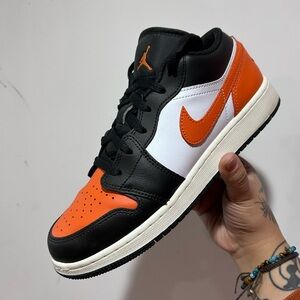 Nike Air Jordan Black, White, and Orange High Tops